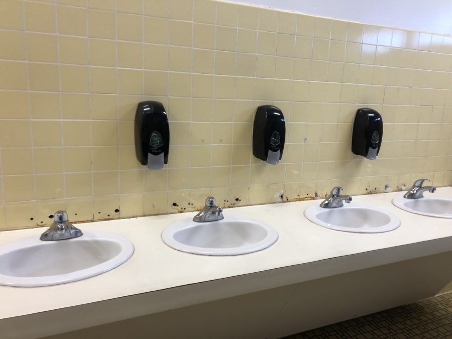 These sinks in the girl's bathroom are missing tiling because the tiling rotted and had to be ripped out.